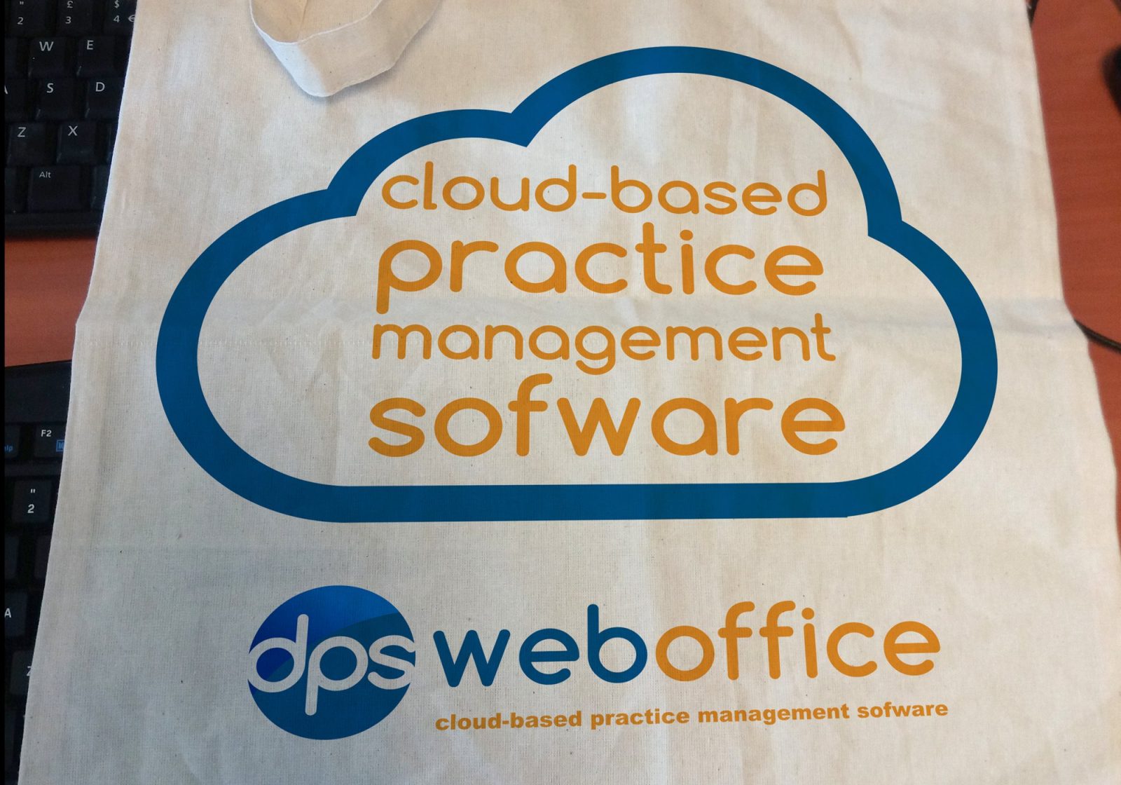 A tote bag for DPS Software showing the cloud logo and text