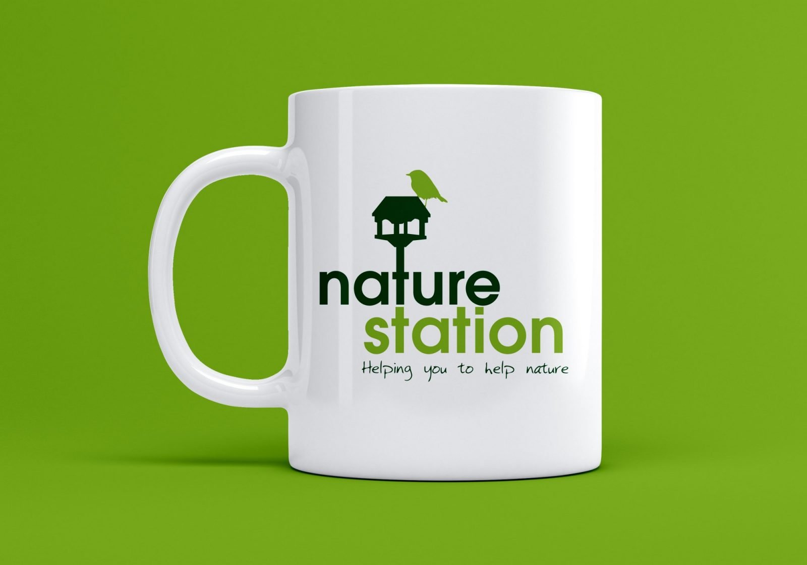 A branded mug showing the logo for Nature Station