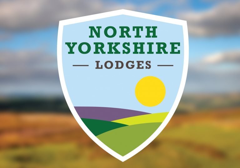 Logo for North Yorkshire Lodges on a blurry background